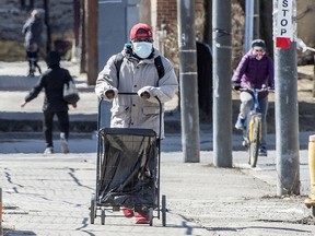 Pedestrians wearing masks on Toronto's Gerrard Street on Friday, March 19, 2021.
