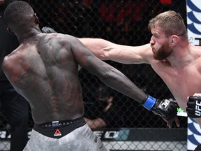 Mar 6, 2021; Las Vegas, NV, USA;  Jan Blachowicz of Poland punches Israel Adesanya of Nigeria in their UFC light heavyweight championship fight during the UFC 259 event at UFC APEX on March 06, 2021 in Las Vegas, Nevada. Mandatory Credit: Jeff Bottari/Handout Photo via USA TODAY Sports