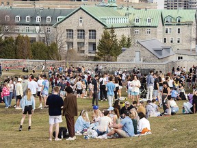 People take advantage of the record-breaking temperatures as they gather in a park in Montreal, Thursday, March 25, 2021.