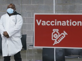 A health-care worker waits for patients  at a COVID-19 vaccination clinic in Montreal's Olympic Stadium on Tuesday, Feb. 23, 2021.