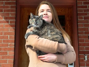 OTTAWA - March 5, 2021 - Forrest Hartman and her cat Schatzi in the Glebe in Ottawa Friday March 5, 2021. Forrest posted a plea, asking the owner of a "cat with a s--t attitude" be kept indoors after repeatedly harassing her own cat and menacing her when she tried to get rid of it.