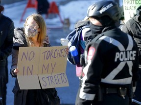 Calgary police where busy keeping the peace as hundreds of anti-mask protesters, some carrying tiki torches, and counter-protesters clashed at city hall on Saturday, Feb. 27, 2021.