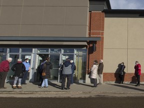 Seniors wait in long lines at an AHS COVID-19 vaccination clinic in south Edmonton on Thursday, Feb. 25, 2021. The chaotic start of general vaccinations for older seniors last week should serve as a wake-up call for a broader rollout to come, writes columnist Rob Breakenridge.