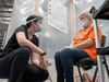 A doctor speaks with a patient on Monday during a demonstration of a mass vaccination clinic in Cobourg, Ont.