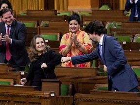 Finance Minister Chrystia Freeland receives a fist-bump from Prime Minister Justin Trudeau after unveiling her first fiscal update.
