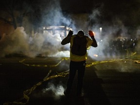 Tear gas fills the air as people confront police outside the Brooklyn Center police headquarters on April 11, 2021 in Brooklyn Center, Minnesota.