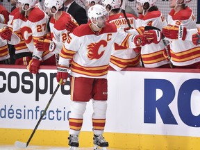 MONTREAL, QC - APRIL 14:  Mark Giordano #5 of the Calgary Flames celebrates his goal with teammates on the bench against the Montreal Canadiens during the second period at the Bell Centre on April 14, 2021 in Montreal, Canada.