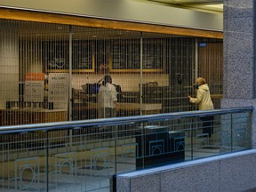 A woman looks into Sunterra Market in Banker's Hall, recently closed due to new COVID-19 restrictions in Calgary on Thursday, April 8, 2021.