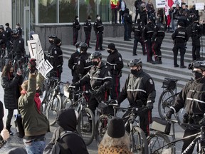 Police line up between anti-mask protestors and counter-protesters at the Alberta legislature in February. Between the extremes of anti-vaxxers/maskers and people who want a total lockdown is the muddled middle, where we're still able to go outside and exercise freedom without unduly endangering the more vulnerable in society.