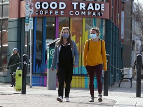 Talia Campbell and Jessica O'Connell are seen wearing their masks while walking Kensington Rd. NW. Thursday, April 8, 2021.
