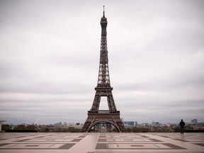 A man walks on the deserted Trocadero square in front of the Eiffel Tower on March 21, 2020, in Paris on the fifth day of a strict nationwide lockdown seeking to halt the spread of the COVID-19 infection.