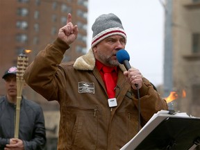 Artur Pawlowski, the pastor of Calgary's Street Church speaks to members of the church as attendees of a Protest Against Racism and members of the Street Church clash while police keep both group separated at Olympic Plaza.  Sunday, April 4, 2021.