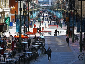 Calgarians walk and enjoy the patios on Stephen Avenue Mall on Monday, April 26, 2021. Calgary city council is considering a 10-year plan to revitalize the downtown core.