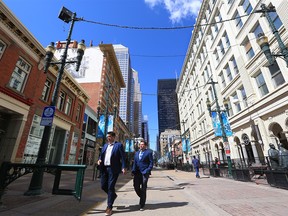 Calgarians walk on Stephen Avenue Mall during the lunch hour on April 26, 2021.