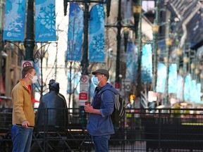 Calgarians talk on Stephen Avenue Mall during the lunch hour on Monday, April 26, 2021. Calgary city council is considering a 10-year plan to revitalize the downtown core.
