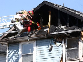 Firefighters are seen putting out a house fire located at 207 Carmel Cl. NE. The fire department says all occupants, including two cats, escaped and suffered no injuries. Friday, April 16, 2021.