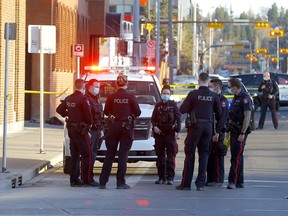 Calgary police investigate a serious stabbing in a back alley on 11 St. and 7 Ave. S.W. in Calgary on Thursday, April 15, 2021. The victim later died in hospital.