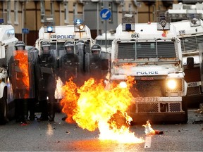 A fire burns in front of the police on the Springfield Road as protests continue in Belfast, Northern Ireland April 8, 2021.
