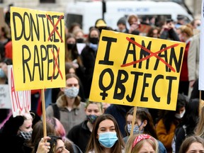 Not until men seriously take up the challenge of eradicating domestic violence will anything truly change, Catherine Ford writes. Pictured, demonstrators hold placards during a rally for women's rights and safety, following the murder of Sarah Everard, in Parliament Square, London, Britain, earlier this month. REUTERS/Toby Melville