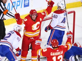 Calgary Flames forward Sean Monahan celebrates with Johnny Gaudreau after scoring on Montreal Canadiens goaltender Carey Price at the Saddledome in Calgary on Saturday, March 13, 2021.