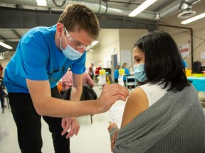 A worker receives a shot at a COVID-19 vaccination clinic at Cargill meat-packing plant in High River on Thursday, April 29, 2021.