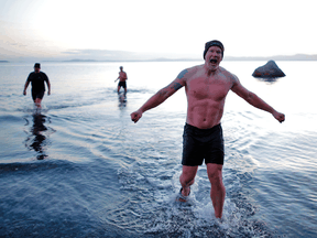 Adam Kreek (centre), Fraser Thomson and Patrick Walter exit the water at Mt. Douglas Park in Victoria on March 26.