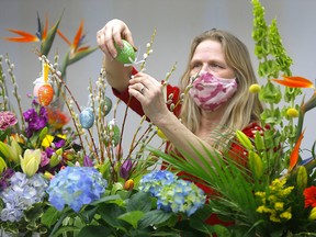 Floral designer Lea Romanowski works on Easter flower arrangements at Kensington Florist in Calgary on Wednesday, March 31, 2021.