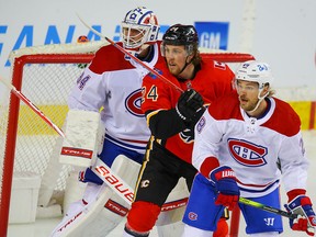 Calgary Flames Brett Ritchie fights for space in front of Canadiens goaltender Jake Allen on Friday April 23, 2021.