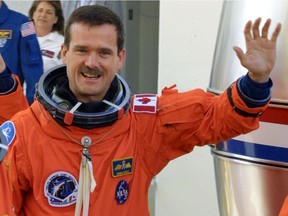 On this day in history: In 2001, Canadian astronaut Chris Hadfield began his second spaceflight as the shuttle Endeavour was launched. On the fourth day of the 13-day mission, Hadfield became the first Canadian to walk in space.  Here, Hadfield waves during the crew walk out for mission STS-100 aboard Endeavour at the Kennedy Space Centre on Thursday, April 19, 2001. (CANADA NEWS WIRE PHOTO/Canadian Space Agency)