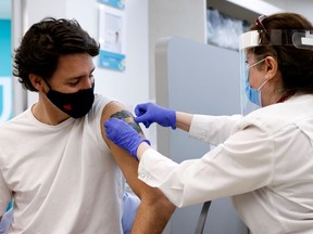 Canada's Prime Minister Justin Trudeau gets a band-aid after being inoculated with AstraZeneca's vaccine against coronavirus disease (COVID-19) at a pharmacy in Ottawa, Ontario, Canada April 23, 2021.   REUTERS/Blair Gable ORG XMIT: GGG-OTW105