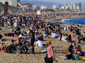 People spend time at Barceloneta beach, amid the coronavirus disease (COVID-19) outbreak, in Barcelona, Spain April 2, 2021.