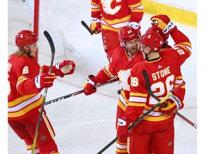 The Calgary Flames celebrate Johnny Gaudreau’s goal against the Edmonton Oilers at the Scotiabank Saddledome in Calgary on Saturday, April 10, 2021.