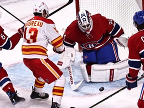 Apr 16, 2021; Montreal, Quebec, CAN; Montreal Canadiens goaltender Jake Allen (34) makes a save against Calgary Flames left wing Johnny Gaudreau (13) as defenseman Shea Weber (6) defends during the first period at Bell Centre. Mandatory Credit: Jean-Yves Ahern-USA TODAY Sports ORG XMIT: IMAGN-445595