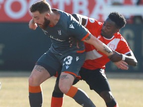 Forge FC Anthony Novak (L) is marked by Cavalry FC Nathan Mavila during leg 2 Canadian Premier League Championship soccer action between Forge FC and Cavalry FC at ATCO Field at Spruce Meadows in Calgary on Saturday, November 2, 2019. Jim Wells/Postmedia