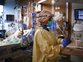 ICU health care worker Jannikka Navaratnam tends to a patient at Humber River Hospital in Toronto on Dec. 9, 2020.