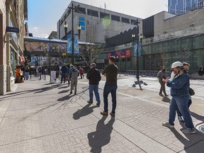 People line up for vaccinations at the mass immunization site at Telus Convention Centre in Calgary on Tuesday, April 20, 2021.