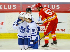 Toronto Maple Leafs captain John Tavares celebrates with teammate William Nylander after scoring a goal against David Rittich of the Calgary Flames during NHL hockey in Calgary on Sunday April 4, 2021. Al Charest / Postmedia