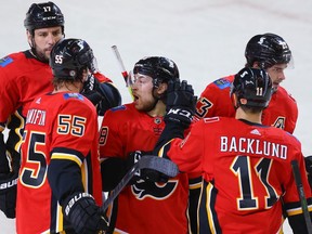 Calgary Flames Andrew Mangiapane celebrates with teammates after scoring a goal against the Montreal Canadiens during NHL hockey in Calgary on Friday April 23, 2021. Al Charest / Postmedia