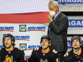 Calgary Flames head coach Darryl Sutter, Johnny Gaudreau and Sean Monahan during a break in play against the Toronto Maple Leafs during NHL hockey in Calgary on Monday April 5, 2021. Al Charest / Postmedia