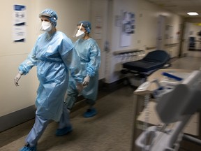 Two nurses do rounds inside the COVID-19 unit of Verdun Hospital in Montreal, on Feb. 16, 2021.