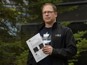 Chad Weyman holds a parking ticket he received while waiting for vaccination at the Telus Convention Centre.