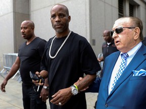 FILE PHOTO: Earl Simmons (C), also known as the rapper DMX, exits the U.S. Federal Court in Manhattan following a hearing regarding income tax evasion charges in New York City, U.S., July 17, 2017.