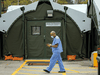 A health care worker walks among the tents of a COVID-19 field hospital in Toronto, April 28, 2021.