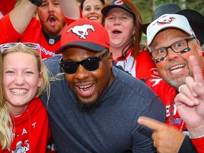 Nik Lewis poses for a photo with Nik Lewis Nation fans during a tailgate party before a game between the Calgary Stampeders and the Montreal Alouettes,the CFL receptions leader signed a one-day contract with Stampeders before announcing his retirement last Friday. Al Charest/Postmedia