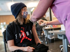 Frankie Webster, 18, receives a COVID-19 vaccine at the Chief Andrew Isaac Health Center in Fairbanks, Alaska, on March 30, 2021.