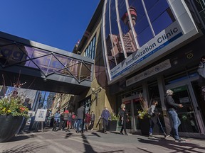 People line up to receive their AstraZeneca vaccines at the immunization clinic at Telus Convention Centre on Tuesday, April 20, 2021.