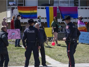 A group of community members have gathered on the lawn neighbouring Street Church, which is holding a gathering despite COVID-19 restrictions, on Saturday, May 1, 2021. The neighbours of the church say they feel unsafe and harassed by the churchgoers and their pastor Artur Pawlowski.