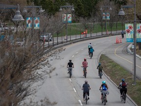 Cyclists ride on eastbound Memorial Drive, which is closed to the traffic, on Saturday, May 1, 2021.