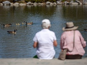 People spend the warm and sunny day along the pond at Prince's Island Park on Saturday, May 15, 2021.