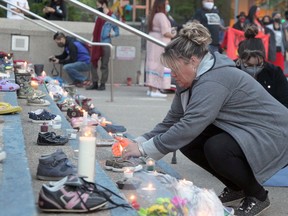 A Candlelight Vigil for the Children of Tkemlups Residential School. 215 pairs of children's shoes were displayed on the steps of City Hall. Saturday, May 29, 2021.